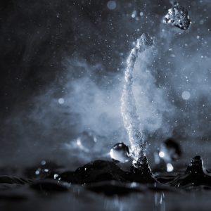 Boiling water splash with steam on black background closeup