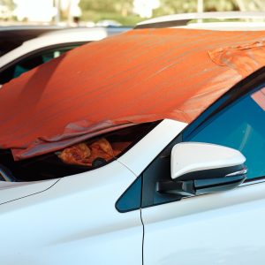 Sun shade made of blanket on car windshield